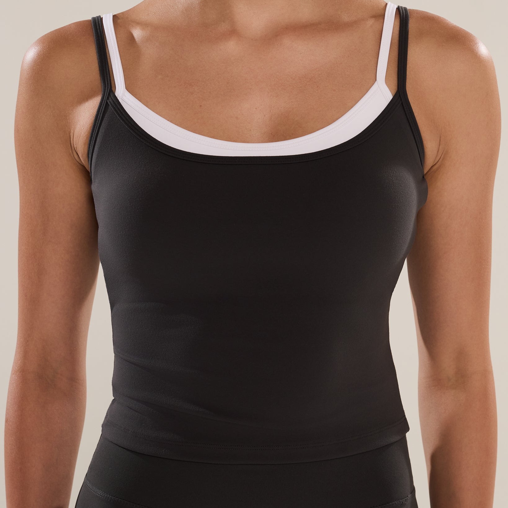 Anya Active Double Up Longline Bra in Stepper, women's charcoal grey layered longline sports bra with contrast white inner straps and open back, front close-up
