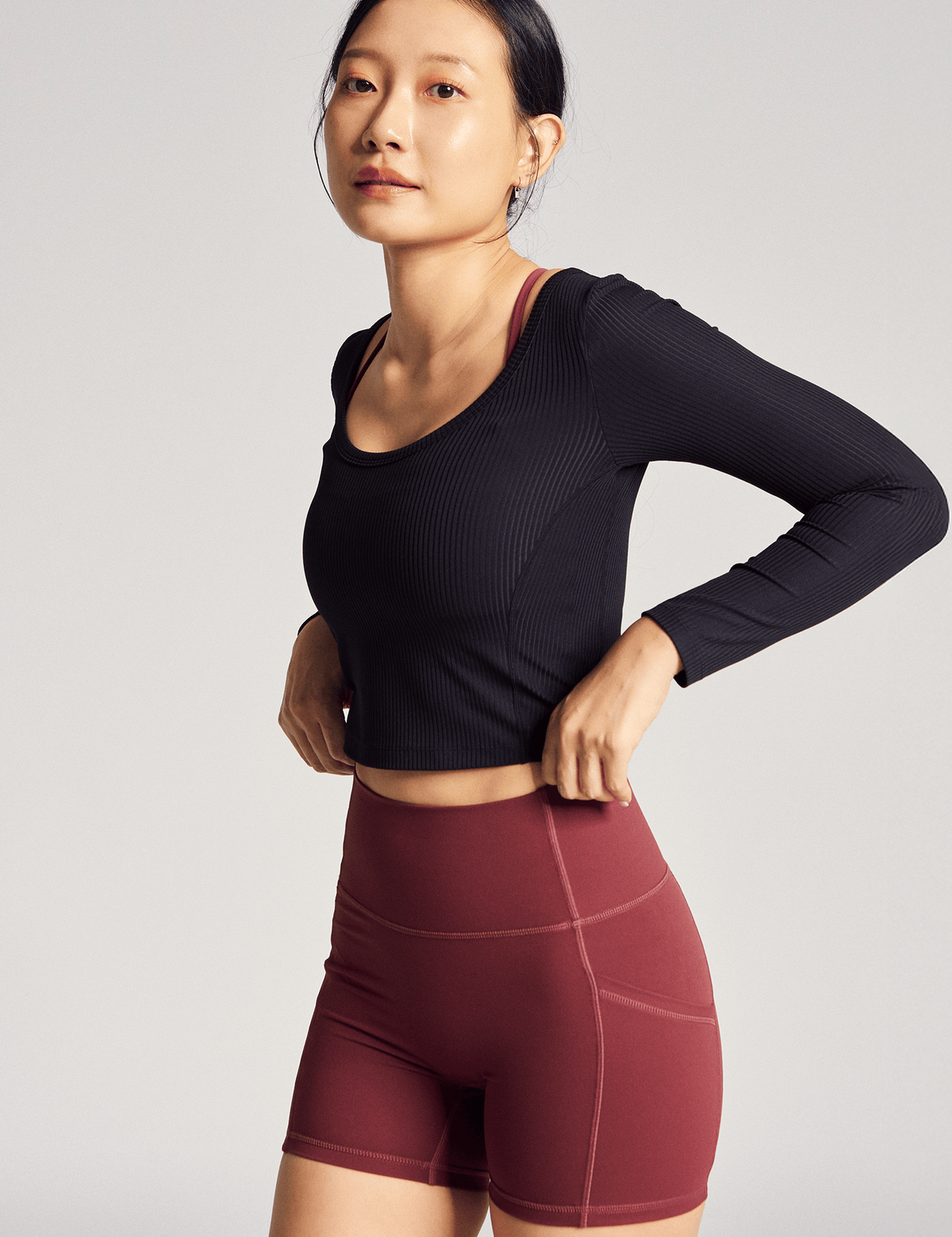 Anya Active Reversible Long Sleeve Top (Rib) in Black Sesame, side view showing the cropped fit